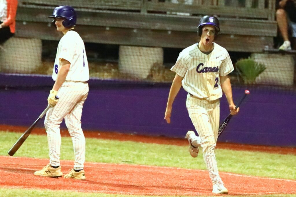 Gainesville's Juan Roman (24) celebrates on his way to the dugout after scoring for a 1-0 lead against Buchholz. Photo by C.J. Gish