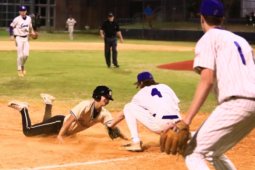 Gainesville's Taylor Brewer (4) tags out Buchholz's Antoine Deleyrolle (23) at third base to end the top of the second inning. Photo by C.J. Gish