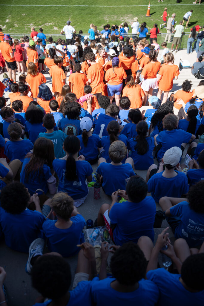 Glenn Springs Elementary School (orange) and Kimball Wiles Elementary School (blue) sit in the stands at Citizens Field.