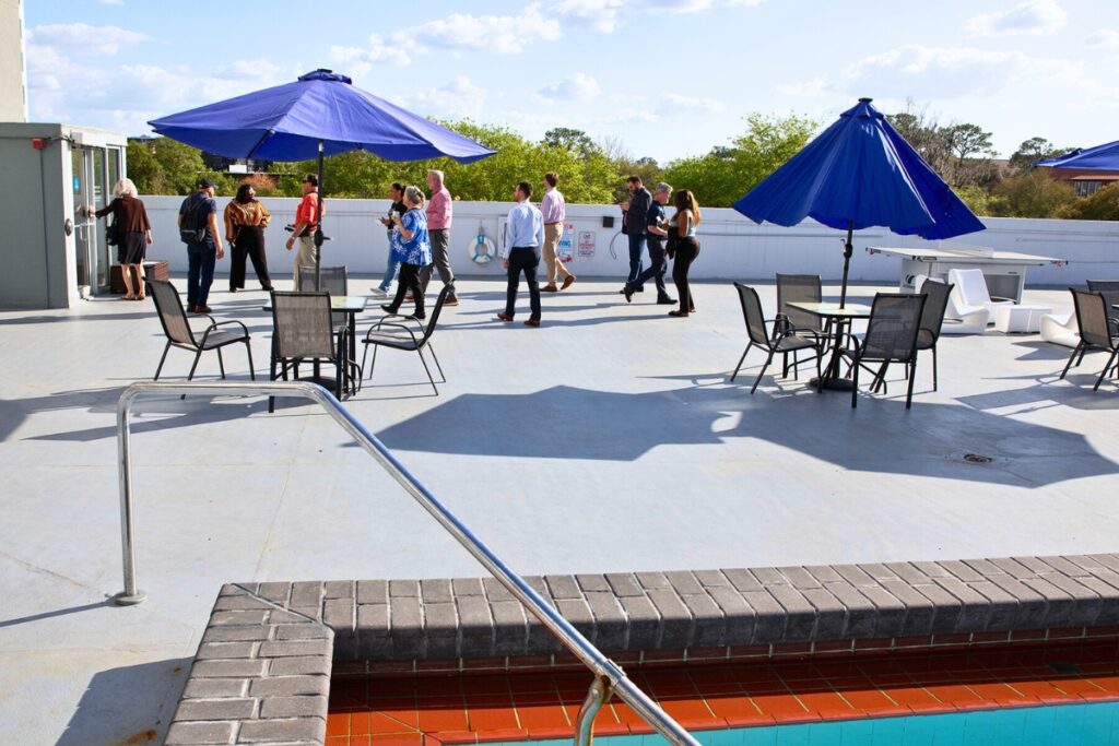 Guests tour the fourth-floor pool deck, which features new furniture and games like corn hole and ping pong. Photo by Megan V. Winslow