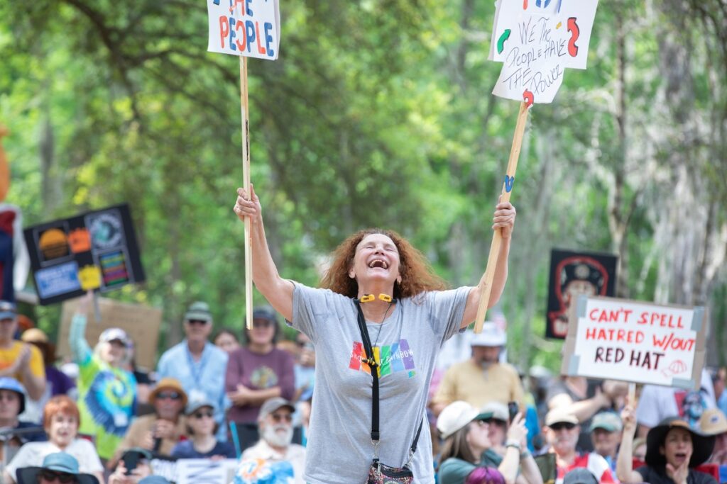 Irma Rivera breaks out into a jubilant dance Saturday during the No Kings protest at Cora P. Roberson Park in Gainesville.