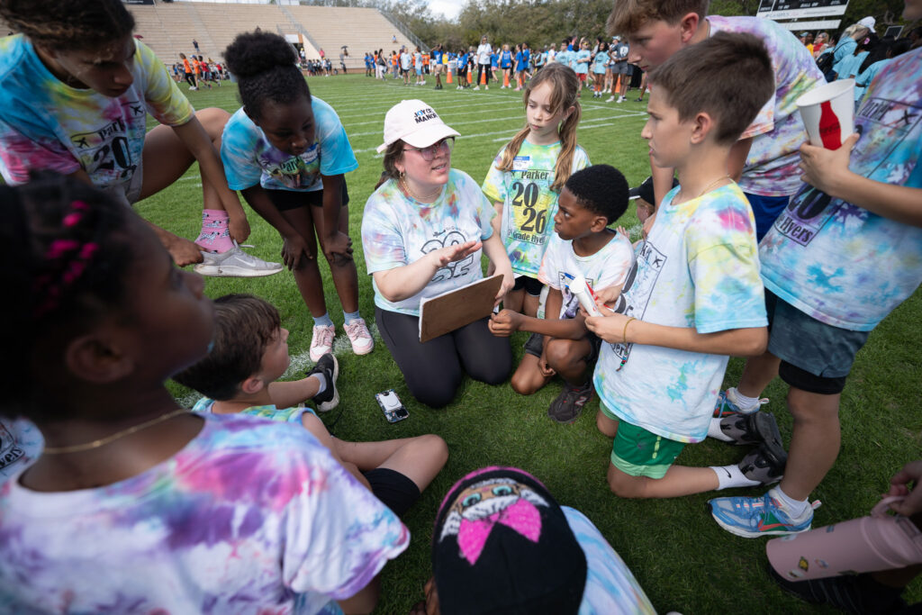 Jocelyn Standard giving her students a pep talk before an event at Citizens Field.