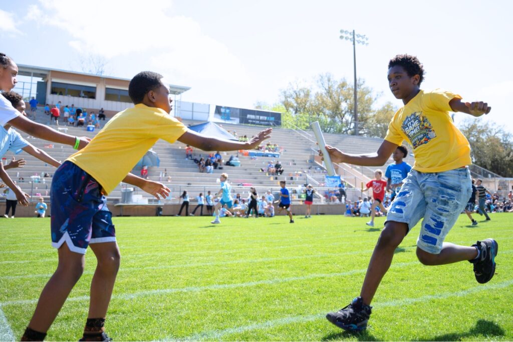 Mosiah Robinson handing the baton to Ricky Barr in the relay race at Citizens Field. Photo by Tim Rodriquez