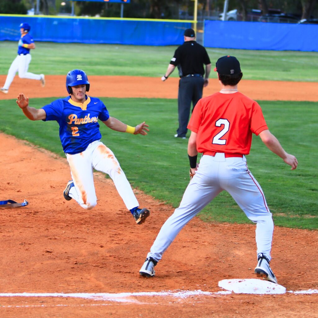 Newberry's Aiden Michaux (2) slides into third base in the bottom of the first inning against Santa Fe's Will Beck (2). Photo by C.J. Gish