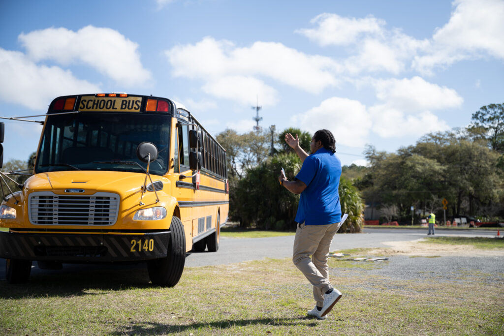 Patrick Spell parking buses in the parking lot after dropping off students at Citizens Field.