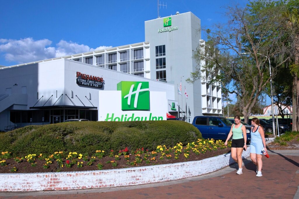 Pedestrians walk by the Holiday Inn Gainesville University Center on Tuesday afternoon. Photo by Megan V. Winslow