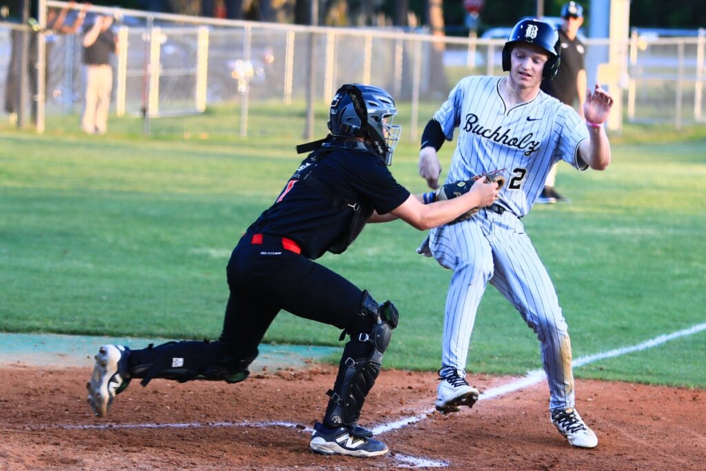 Santa Fe catcher Cole Crevasse (7) tags Buchholz's Aidan Kastensmidt (2) in the second inning. Photo by C.J. Gish