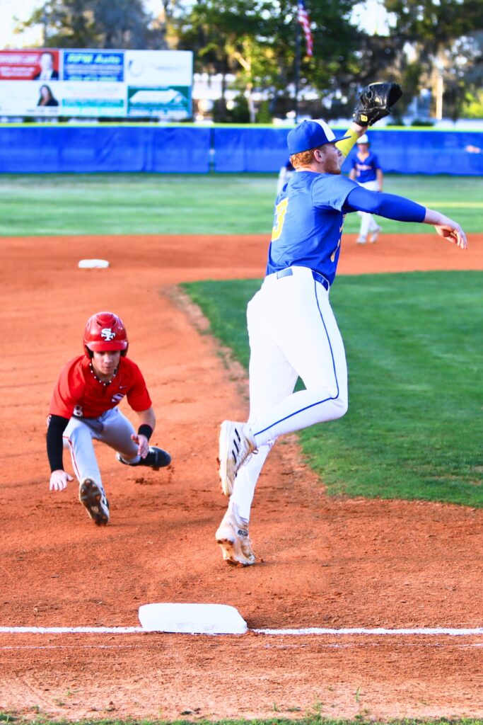 Santa Fe's Dylan Doria (8) steals third base in the first inning against Newberry's Koleby Benson (3). Photo by C.J. Gish1