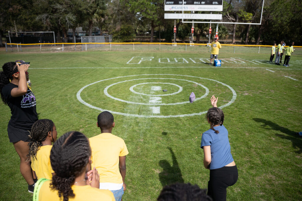 Students toss bean bags at Citizens Field.