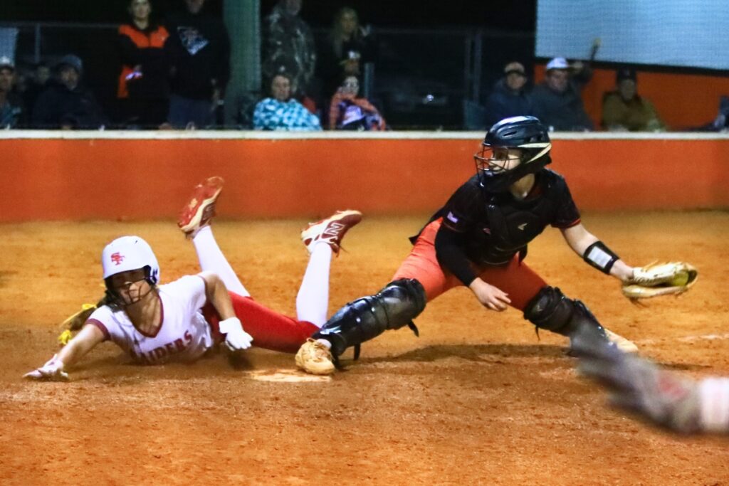 Trenton catcher Khloe Kirby gets the out against Santa Fe's Callie Blair in the top of the eighth inning. Photo by C.J. Gish