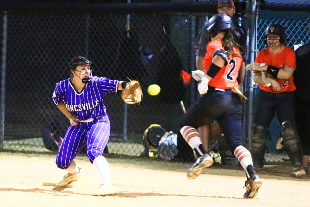 Trenton's Addison Allaire (2) gets thrown out at first base on a toss to Gainesville's Aubree Suarez (7) in the sixth inning. Photo by C.J. Gish
