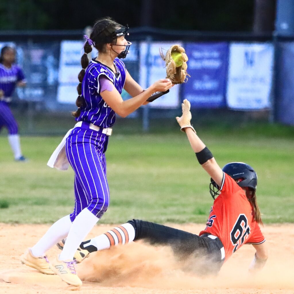 Trenton's MacKenzie Fisher (65) beats the throw to Gainesville's Lana Renicks (15) for a steal in the fourth inning. Photo by C.J. Gish