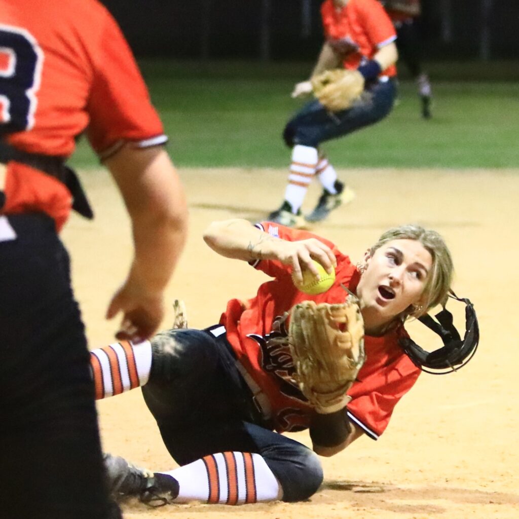 Trenton's Madison Hinote (22) makes a diving catch for the second out in the bottom of the ninth inning against Gainesville. Photo by C.J. Gish