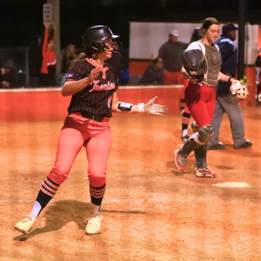Trenton's Montana Moen (8) scores the winning run in a 4-3 extra-inning win over visiting Santa Fe (Alachua). Photo by C.J. Gish