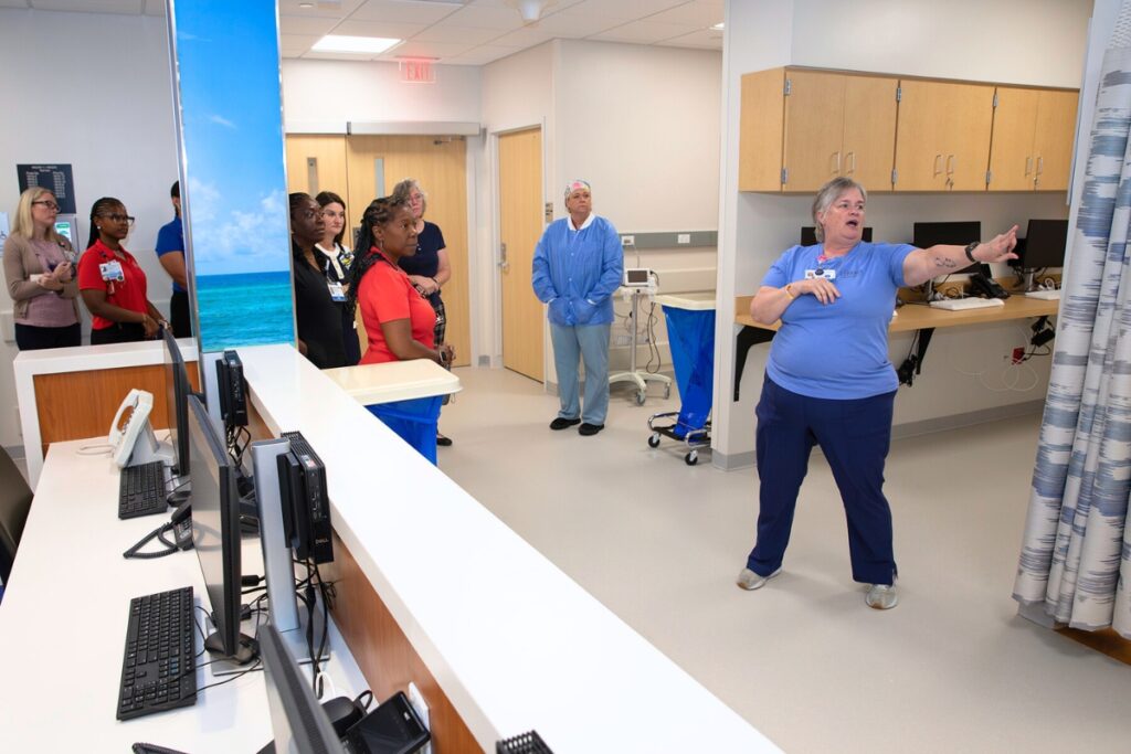 UF Health nurse Valerie Kelly-Gillispie shows guests the PACU, or post-anesthesia care unit, where patients recover after operations. Photo by Megan V. Winslow