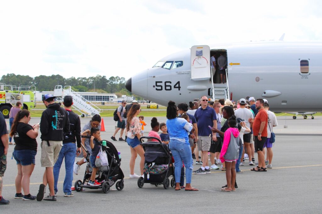 Attendees wait to enter the Navy's Attendees wait to enter the Navy’s P-8 Poseidon at the 8th annual Gator Fly-In and Armed Services Appreciation Day.