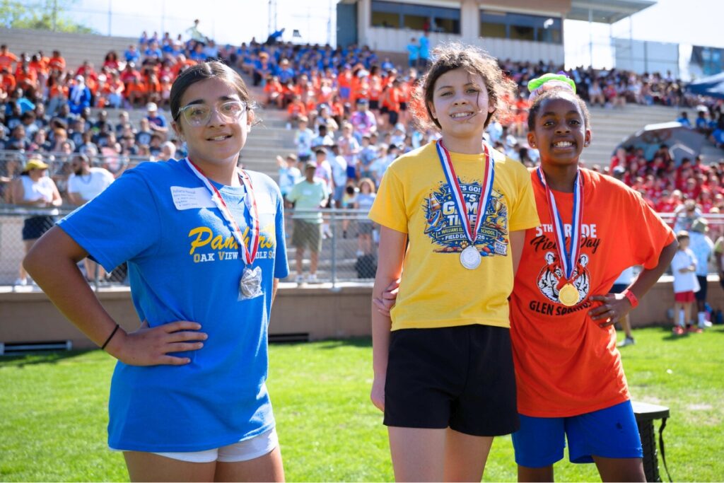 Winners of the mile race (from left) Juliana Nazzal (third), Emmie Gatson (second) and Brooklynne Lane (first) at the Fifth Grade Field Day at Citizens Field. Photo by Tim Rodriquez