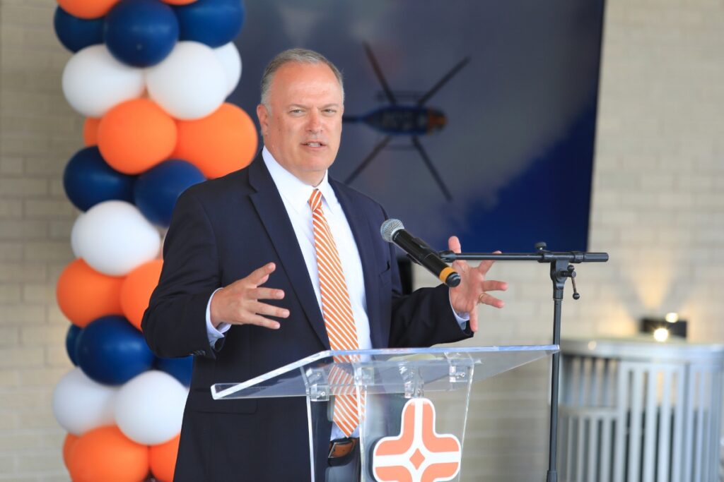 Brandon Ryan, vice president of business development for Air Methods, speaks at Gainesville's ribbon cutting event. 