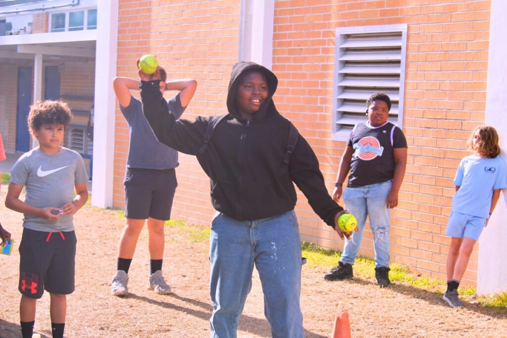 A student tosses a ball at the dunk tank. Photo by Nick Anschultz