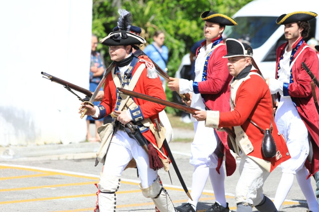 Actors depict British troops charging colonists during the Battles of Lexington and Concord.