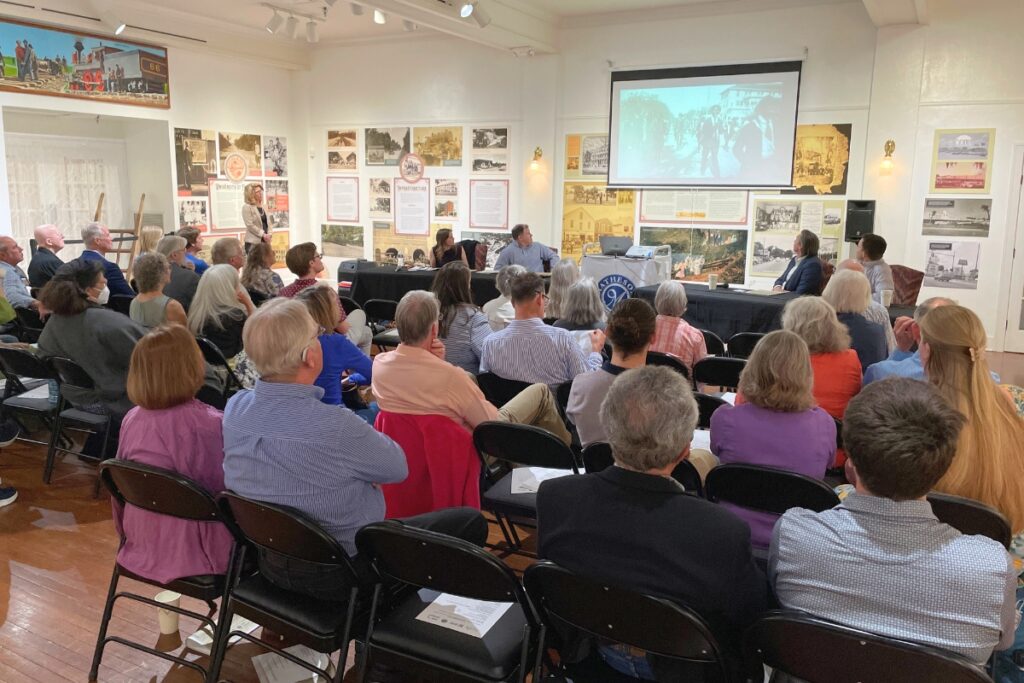 Attendees watch a video from Florida Humanities.