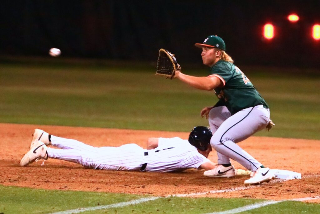 Buchholz's Hudson Sapp (1) dives safely back to first base against Mandarin (Jacksonville) in the 6A-Region 1 Quarterfinals. Photo by C.J. Gish