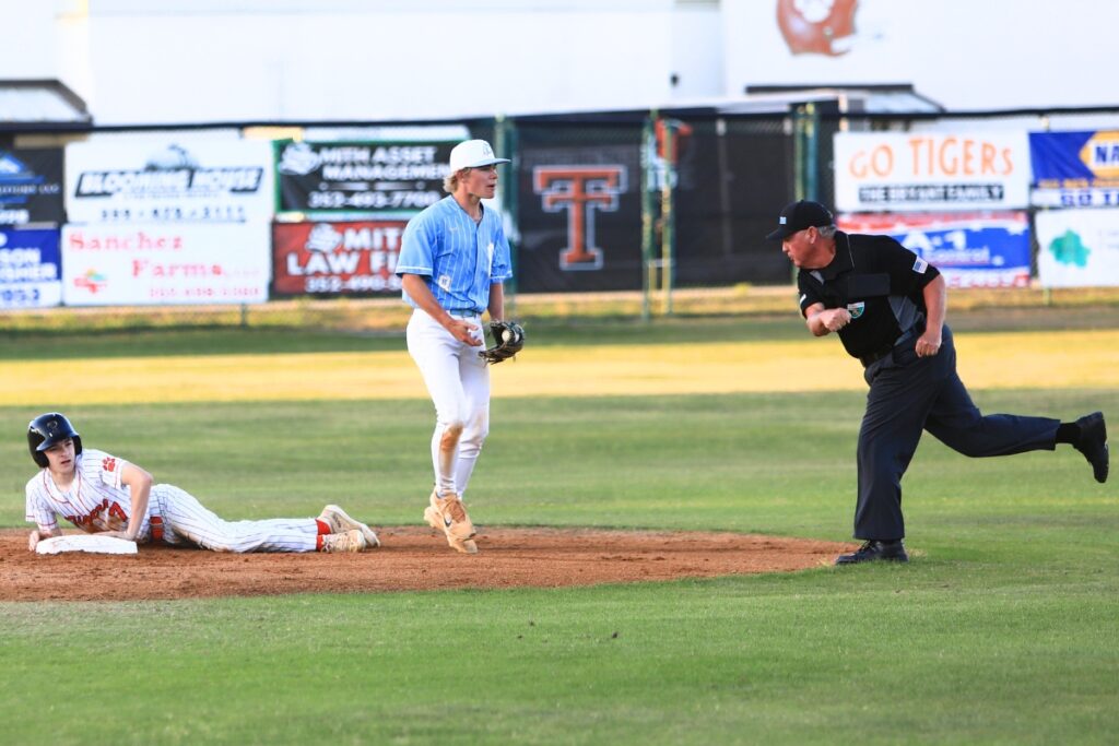 Chiefland's Levi Coe (8) celebrates after tagging Trenton's Brayden Cobb (7) out at second base in the Rural-District 7 semifinals. Photo by C.J. Gish