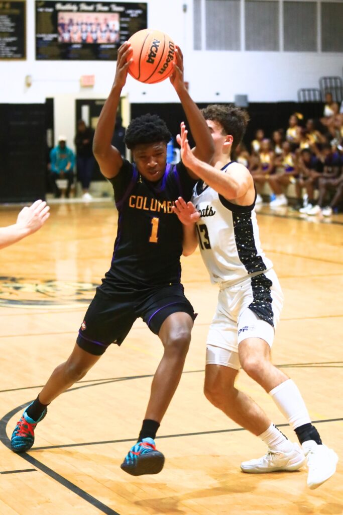 Columbia's Shaheed White (1) drives on Buchholz's Jamison McTureous (13). Photo by C.J. Gish