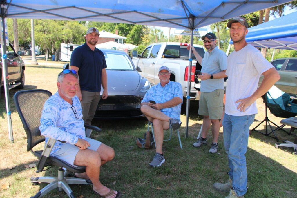 Commissioners Mark Clark (seated left) and Rick Coleman (seated right) sit outside Mentholee Norfleet Municipal Building as voters file in for elections.
