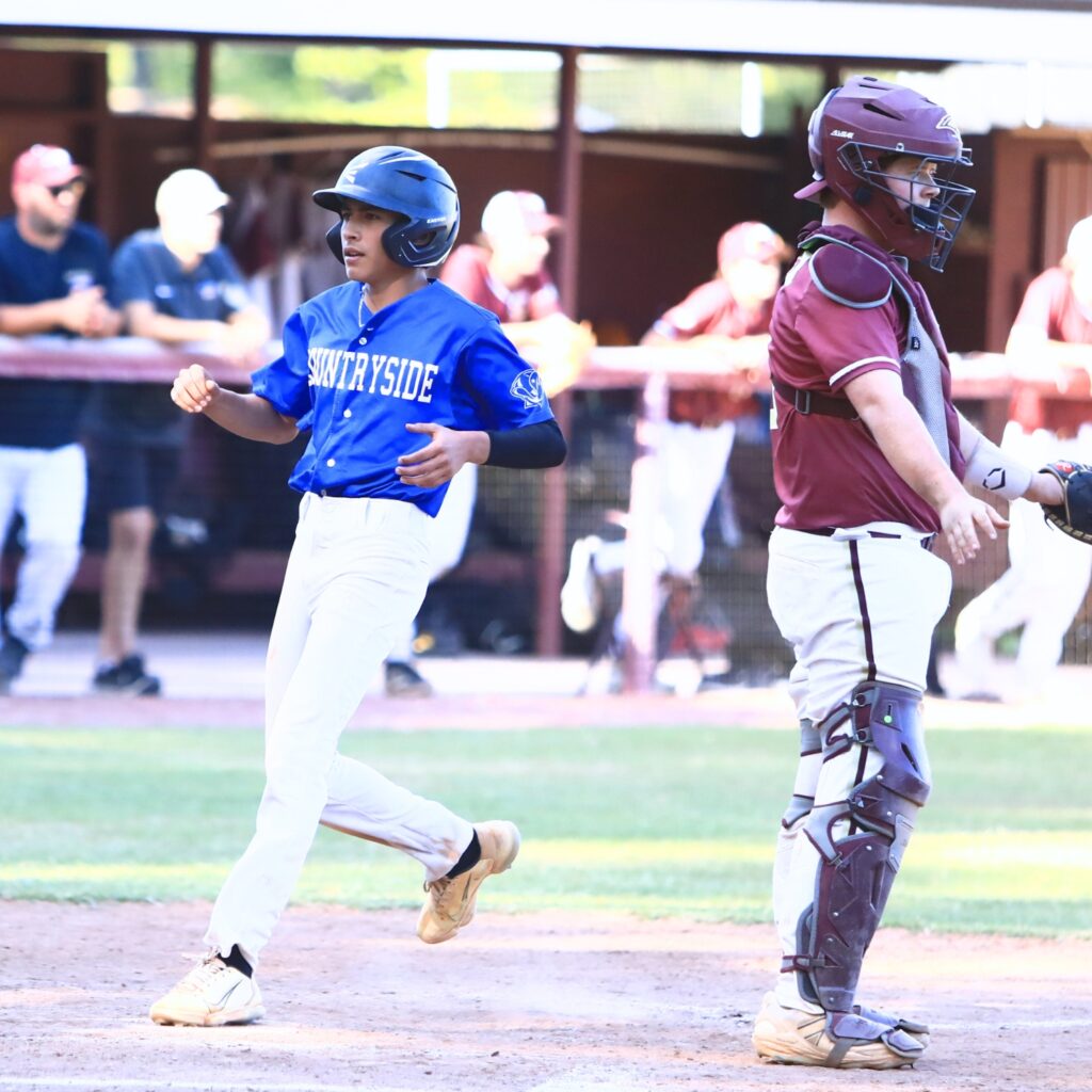 Countryside Christian's Eli Orozco (11) scores in the top of the fourth inning to tie the game 5-5 against Oak Hall in the Class 1A-District 5 semifinals. Photo by C.J. Gish