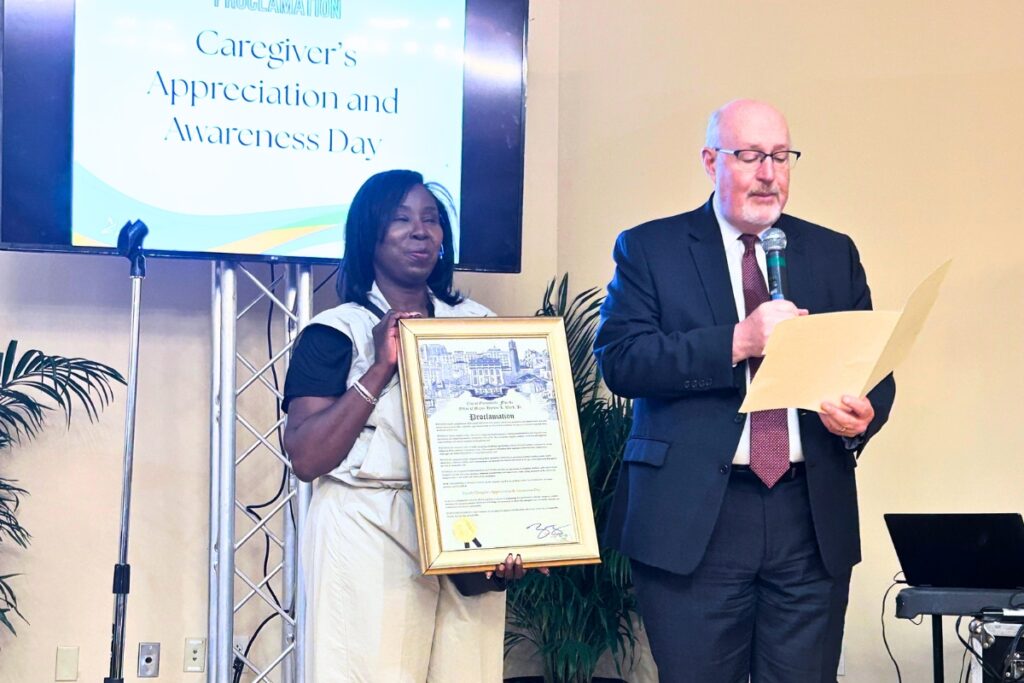 Event organizer and founder of Assurance Virginia Grant, left, with Gainesville Mayor Harvey Ward in recognition of Family Caregivers Appreciation and Awareness Day.  Photo by Ronnie Lovler