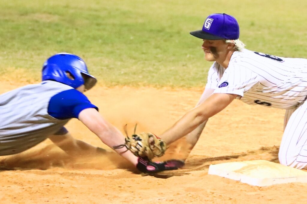 Gainesville's Broc Tucker (6) with tags the Belleview runner out at third base in a Class 5A-District 5 semifinal. Photo by C.J. Gish