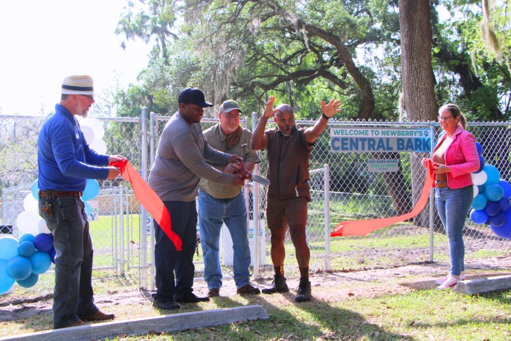 Newberry staff and commissioners cut the ribbon opening Newberry's first dog park. Photo by Lillian Hamman