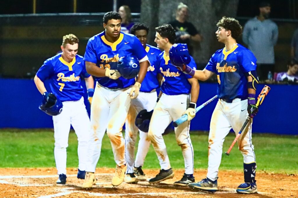 Newberry's Tavis Honeycutt (22) celebrates with teammates at home plate after hitting a 3-run home run in the bottom of the fourth inning against Columbia. Photo by C.J. Gish