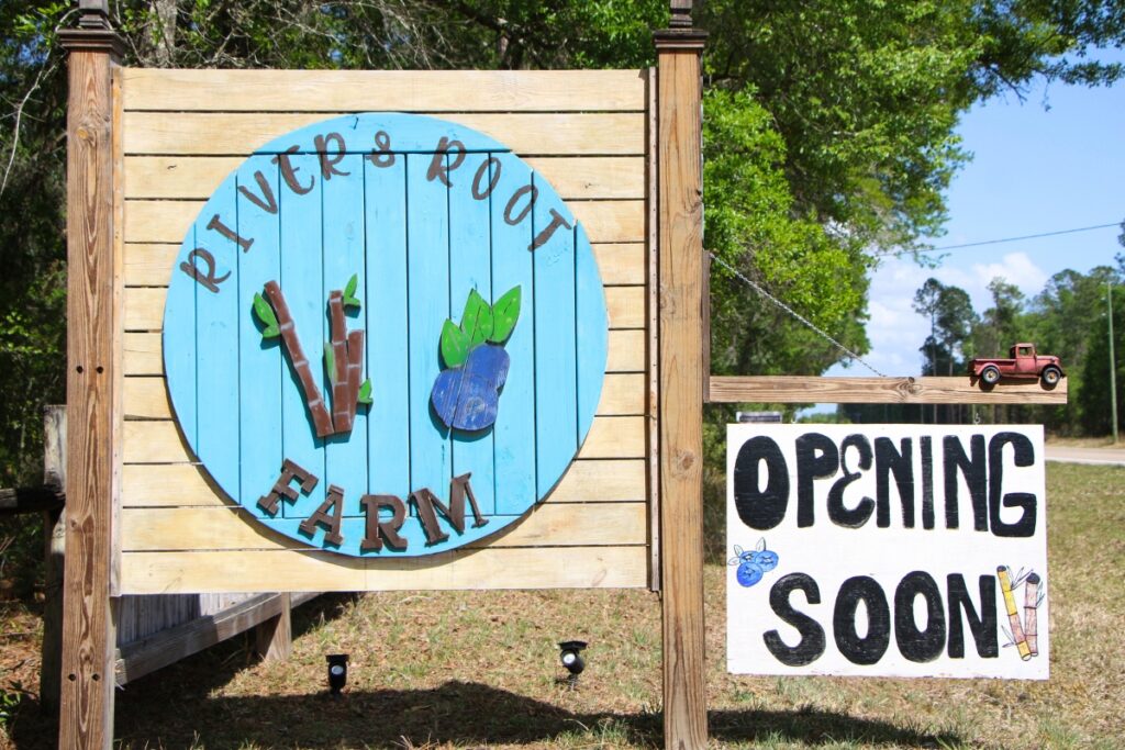 A River & Root Farm sign at the entrance.