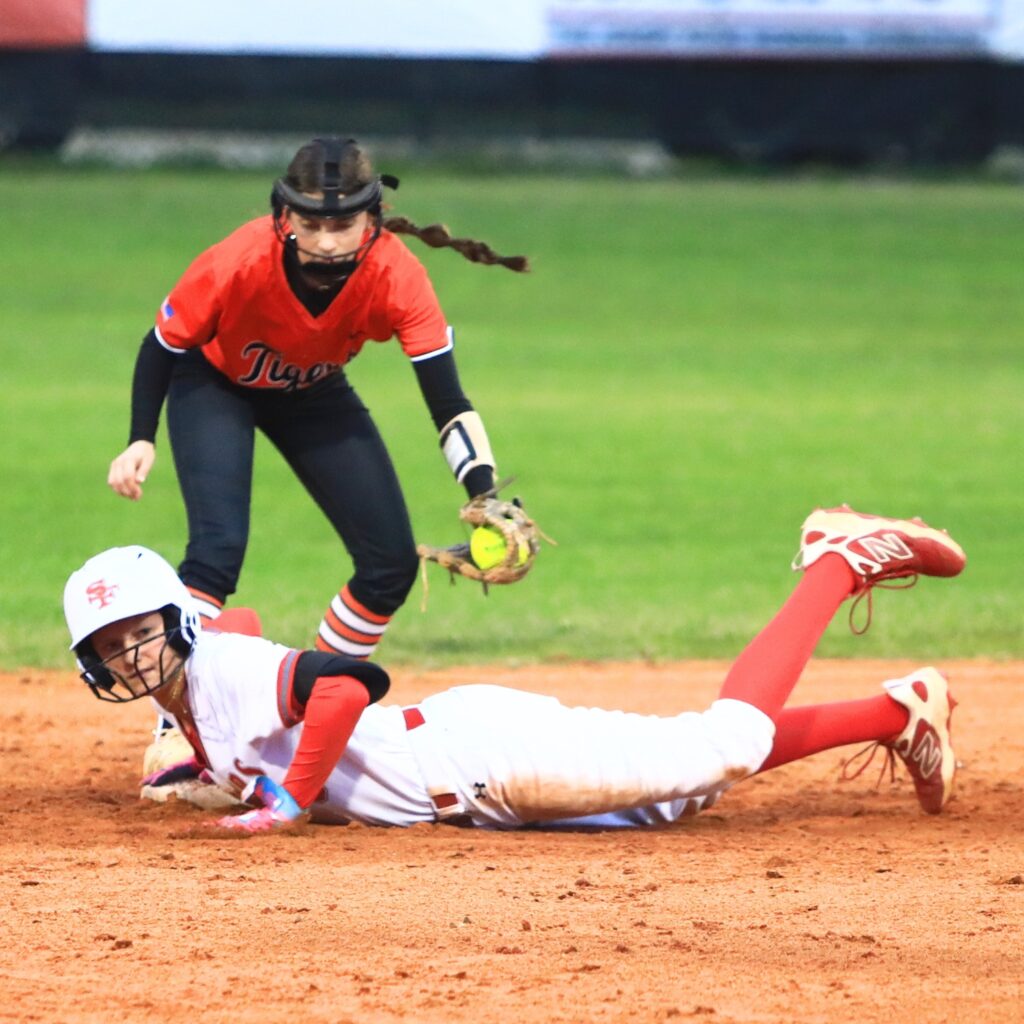 Santa Fe's Corie Wheeler (8) steals second base in the bottom of the second inning against Trenton's Lexi Faught (12). Photo by C.J. Gish