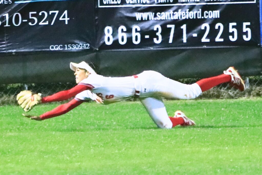 Santa Fe's Madisen Crosby (6) makes a diving catch for the first out in the top of the sixth inning against visiting Trenton. Photo by C.J. Gish