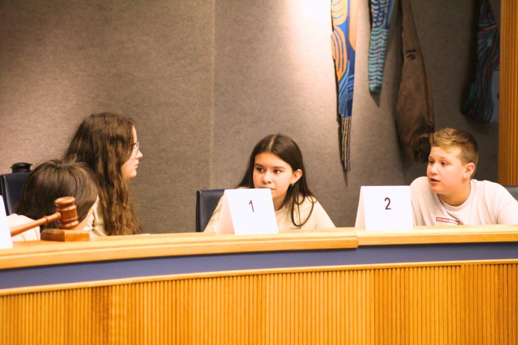 Students talk over an answer. Photo by Nick Anschultz