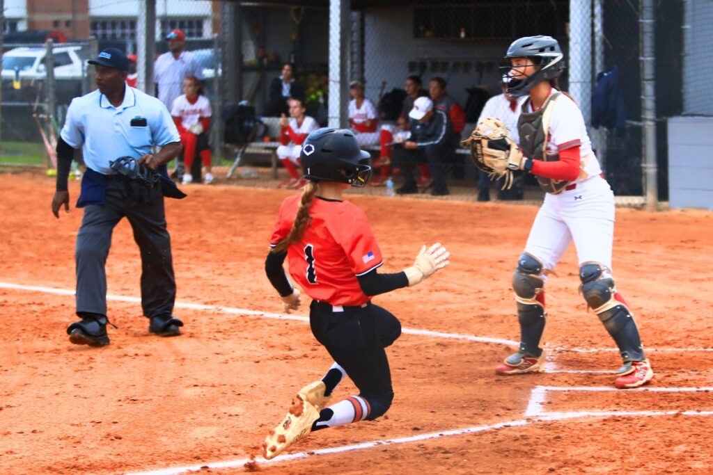 Trenton pinch runner Emily Winfield (1) slides safely home in the top of the first inning for a 1-0 lead at Santa Fe. Photo by C.J. Gish