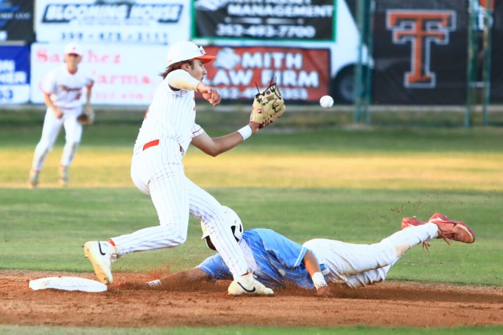 Trenton's Brant Bivens barely misses making the tag on Chiefland's Jolan Doty stealing second base in the Rural-District 7 semifinals. Photo by C.J. Gish
