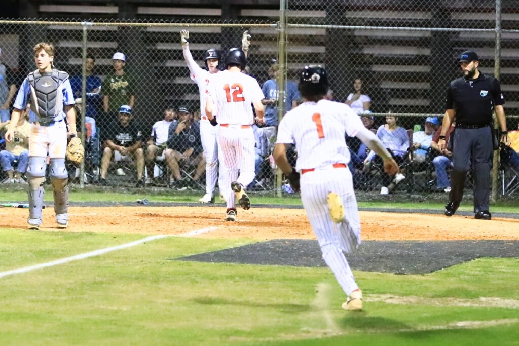 Trenton's Noah Owens (12) and Brant Bivens (1) score in the bottom of the fifth for a 4-0 lead over Chiefland in the Rural-District 7 semifinals. Photo by C.J. Gish