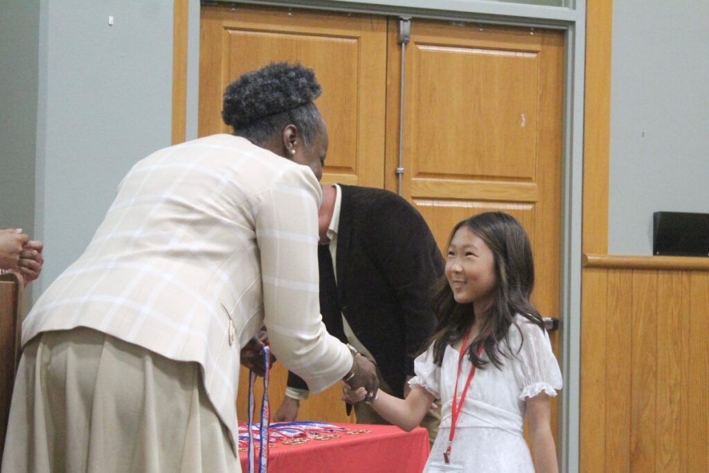 A Citizen of the Year honoree accepts her medal.