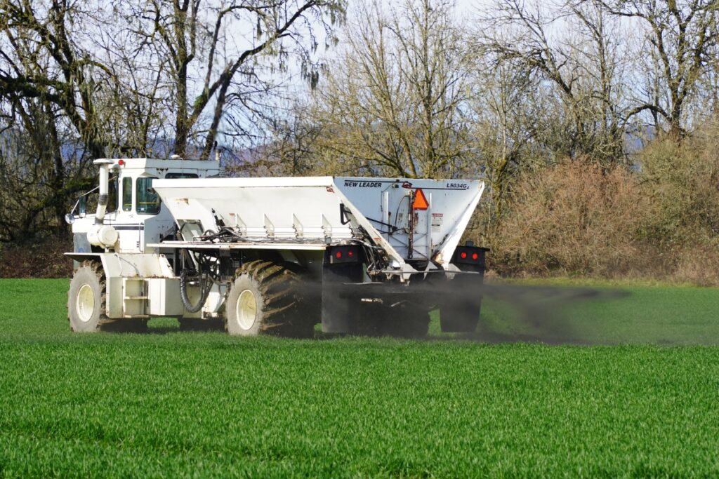 A truck spreads basalt dust as a top amendment on a field. Photo by David Foster - UFIFAS