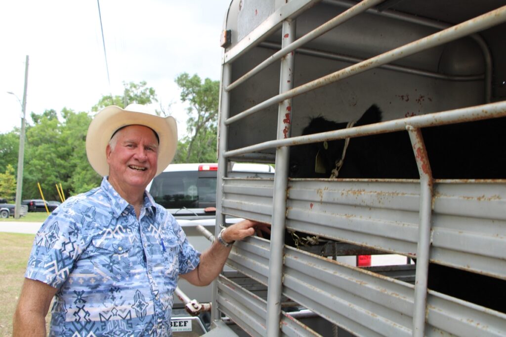 D.J. McGlothern shares his award-winning cow 'Queenie' with Archer Train Day attendees.