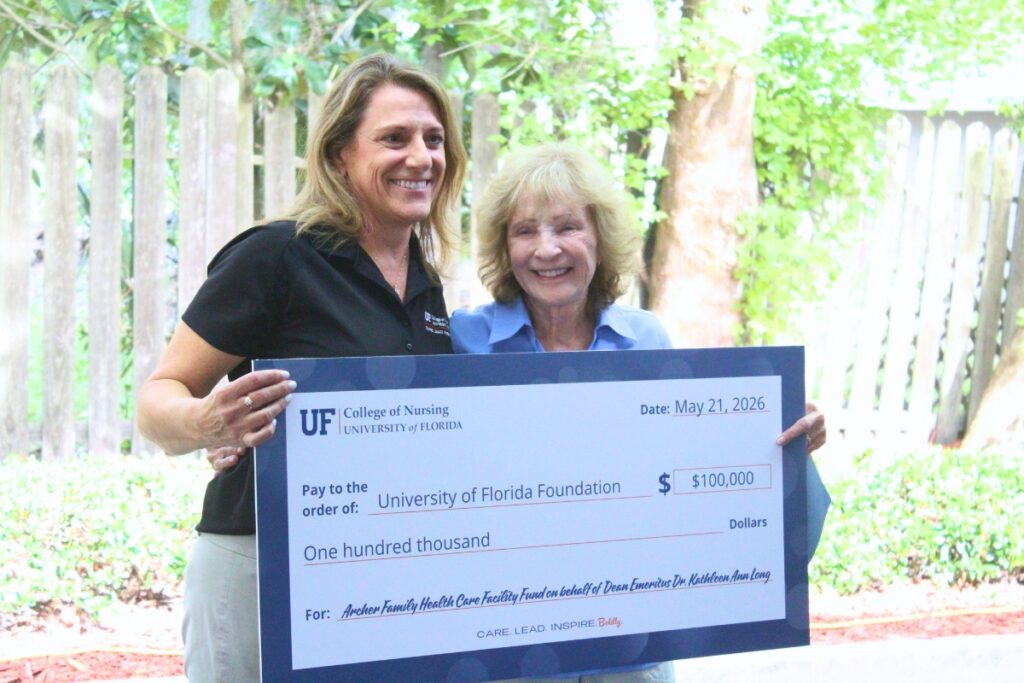 Denise Schentrup and UF College of Nursing Dean Emerita Dr. Kathy Long pose with a check for $100,000 gifted by Long. Photo by Nick Anschultz
