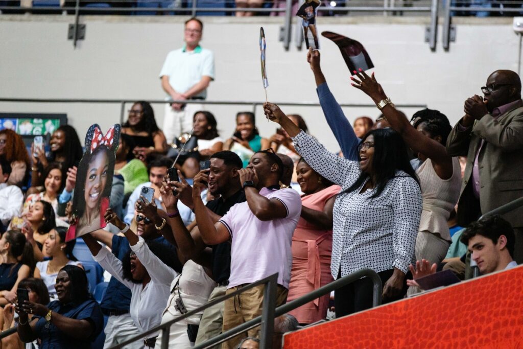 Family and friends celebrate as grads walk across the stage