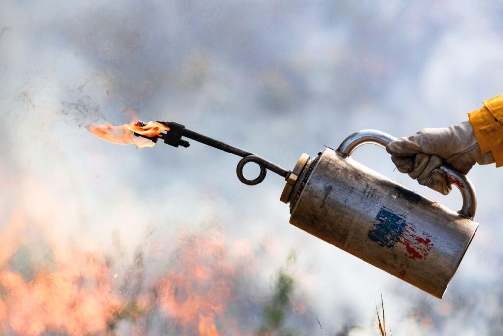 Firefighter holding a drip torch at Ordway Swisher Biological Station. Photo by Tyler Jones - UF-IFAS
