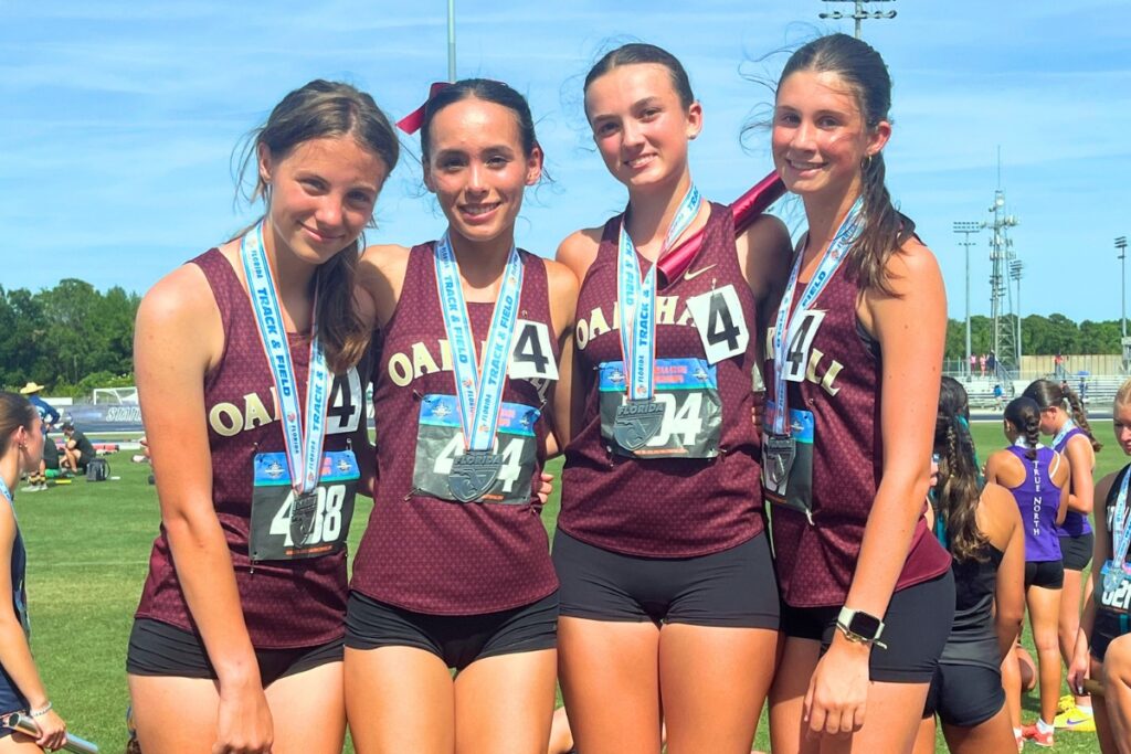 (From left) Oak Hall seventh-grader Reese Allen, senior Estella Collante, junior Lola Murfee and sophomore Alexis Thur de Koos finished fourth in the 4x800-meter relay. Photo by Mike Ridaught