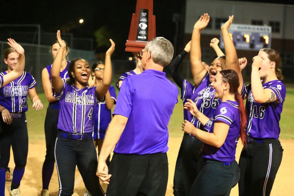 Gainesville celebrates after capturing its third straight district championship in a 7-6 win over Deltona. Photo by C.J. Gish