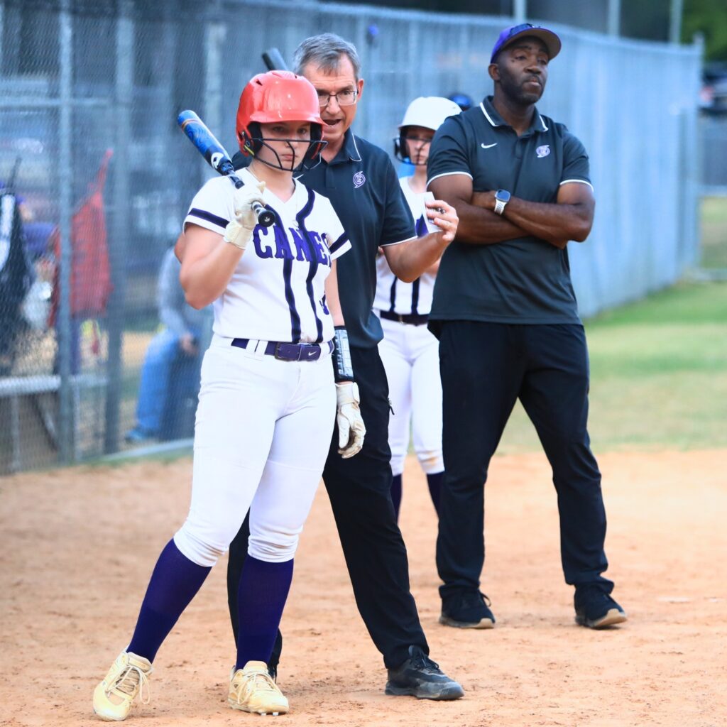 Gainesville coach Chris Chronister talks with Makenna Young (1) in the third inning against Deltona in the Class 5A-Region 2 Quarterfinal. Photo by C.J. Gish
